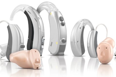 Different Types of Hearing Aids On Display In The White Background.