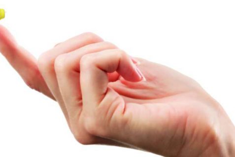 A Woman Hand Holding An Invisible Hearing Aid.