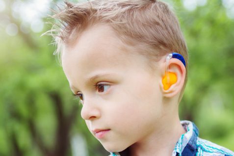 A Portrait of Little Boy Wearing Hearing Aid.