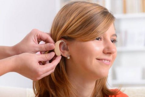 Representing An Audiologist Wearing Hearing Aid To Her Patient.