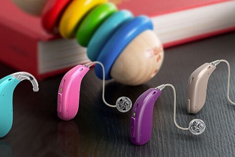 Colorful Hearing Aids Placed On The Table.