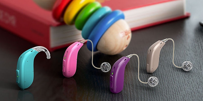 Colorful Hearing Aids Placed On The Table.