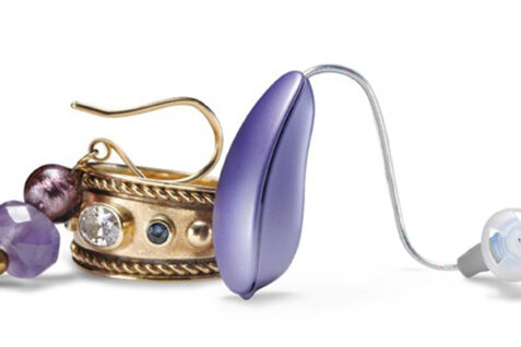 Portable Hearing Aid Paired With An Earing For Display.