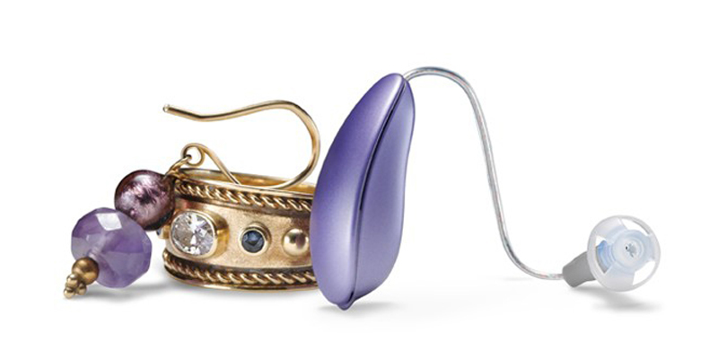 Portable Hearing Aid Paired With An Earing For Display.